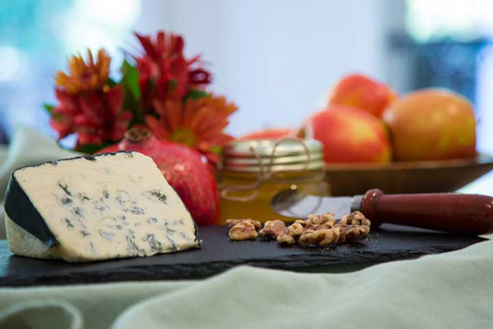 Cheese board with apples, bleu cheese walnuts and honey