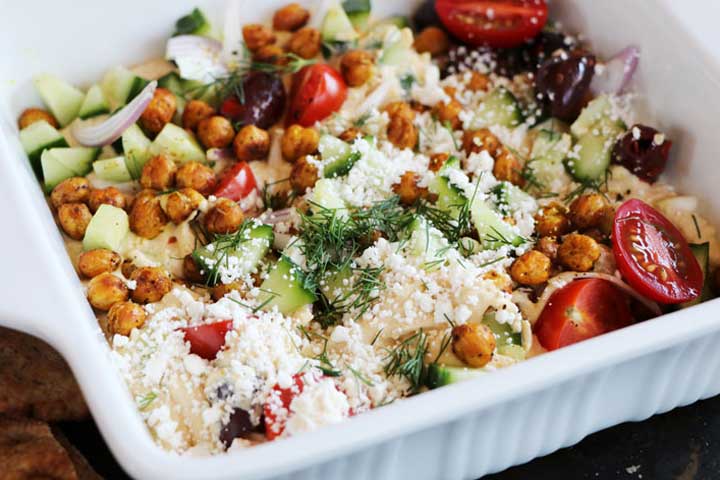 loaded greek hummus in baking dish