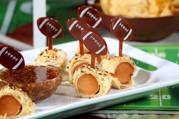 Bagel Dogs on platter with honey mustard and football toothpicks