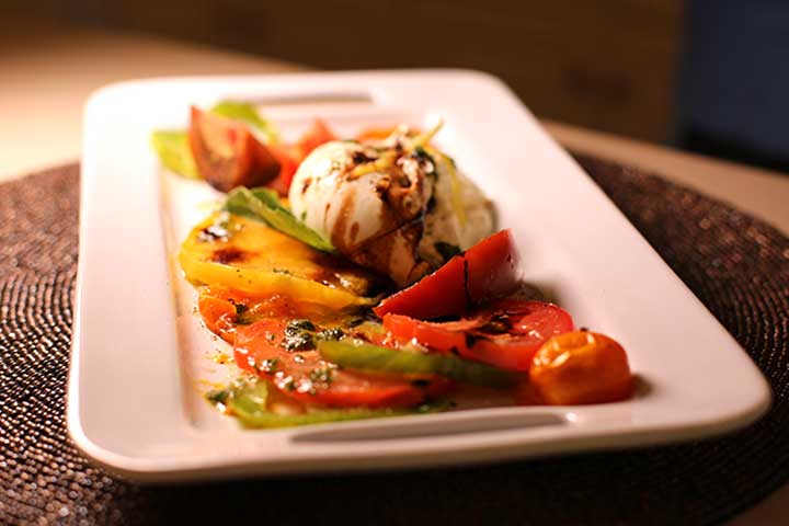 Burrata salad with red, green and yellow heirloom tomatoes