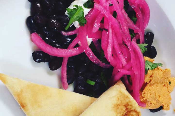 black beans topped with quick pickled red onions