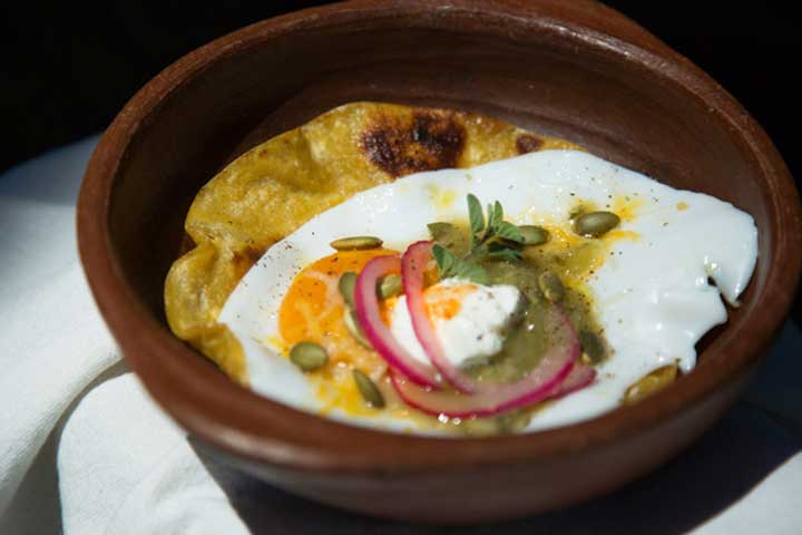 Tostada with fried egg and quick pickled red onions