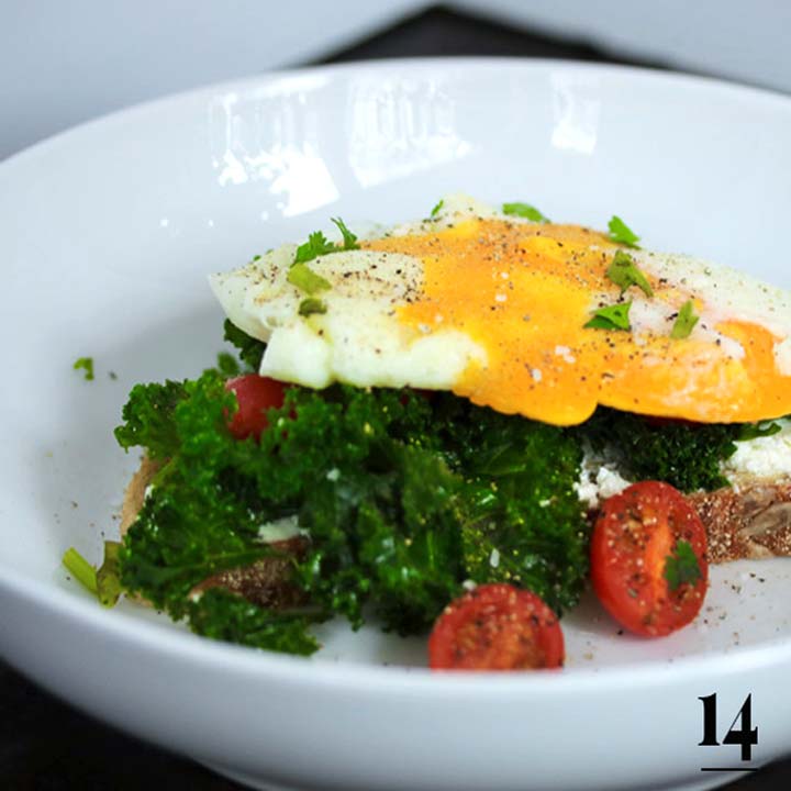 sauteed cherry tomatoes and kale, fried eggs and goat cheese toast 