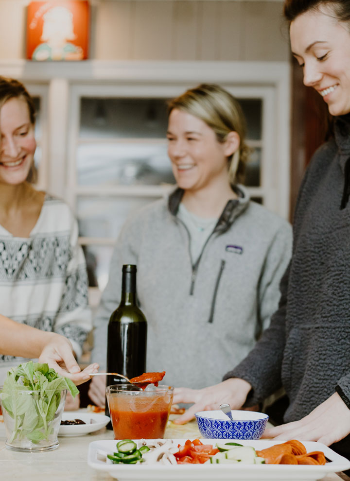 girls making pizzas at home